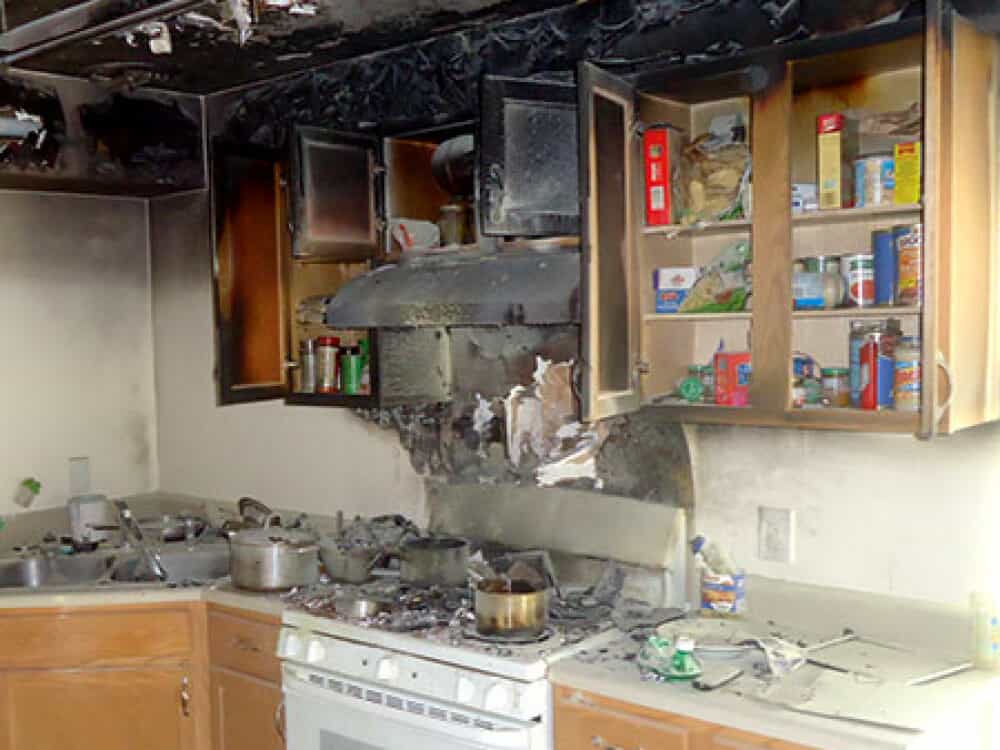 Damaged and burnt kitchen above and around the stove