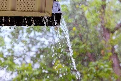 Water spilling over clogged gutters