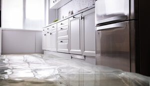 Flooded kitchen in home needing water damage mitigation and restoration services