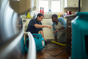 Restoration company in Canoga Park talking with homeowner about water damage restoration